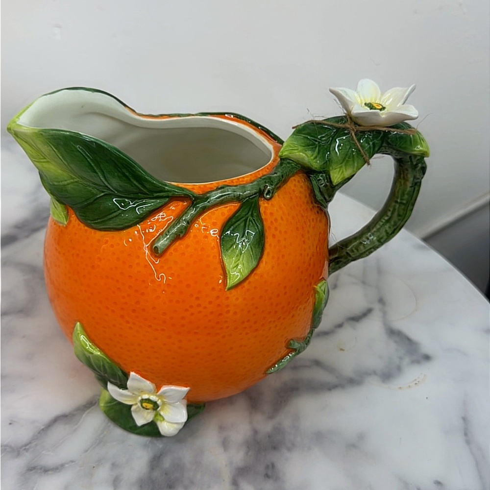 Orange Ceramic Pitcher with Leaf and Flower Accents